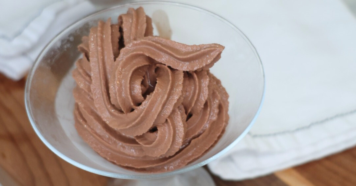 Homemade Ninja Creami chocolate soft serve ice cream made without refined sugar, creamy and healthy dessert in a bowl