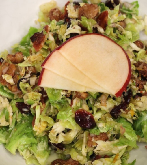 shredded burssels sprouts salad for fall with candied walnuts and orange vinaigrette