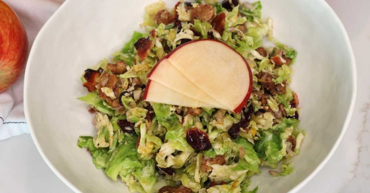 shredded burssels sprouts salad for fall with candied walnuts and orange vinaigrette
