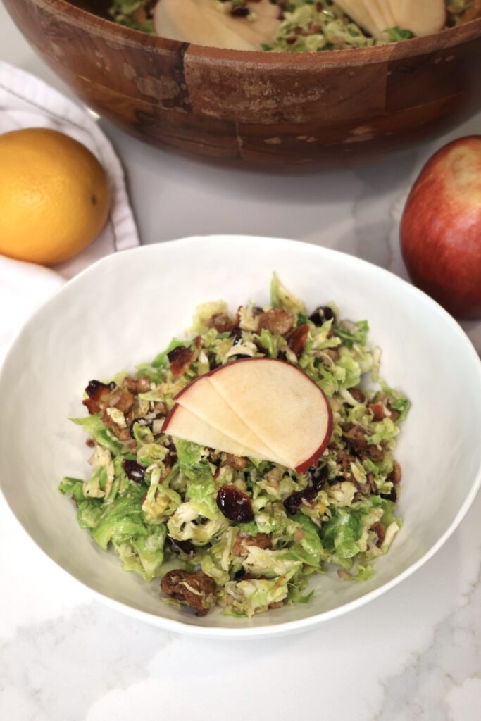brussels sprouts salad with candied walnuts and orange vinaigrette for fall. healthy fall salad recipe