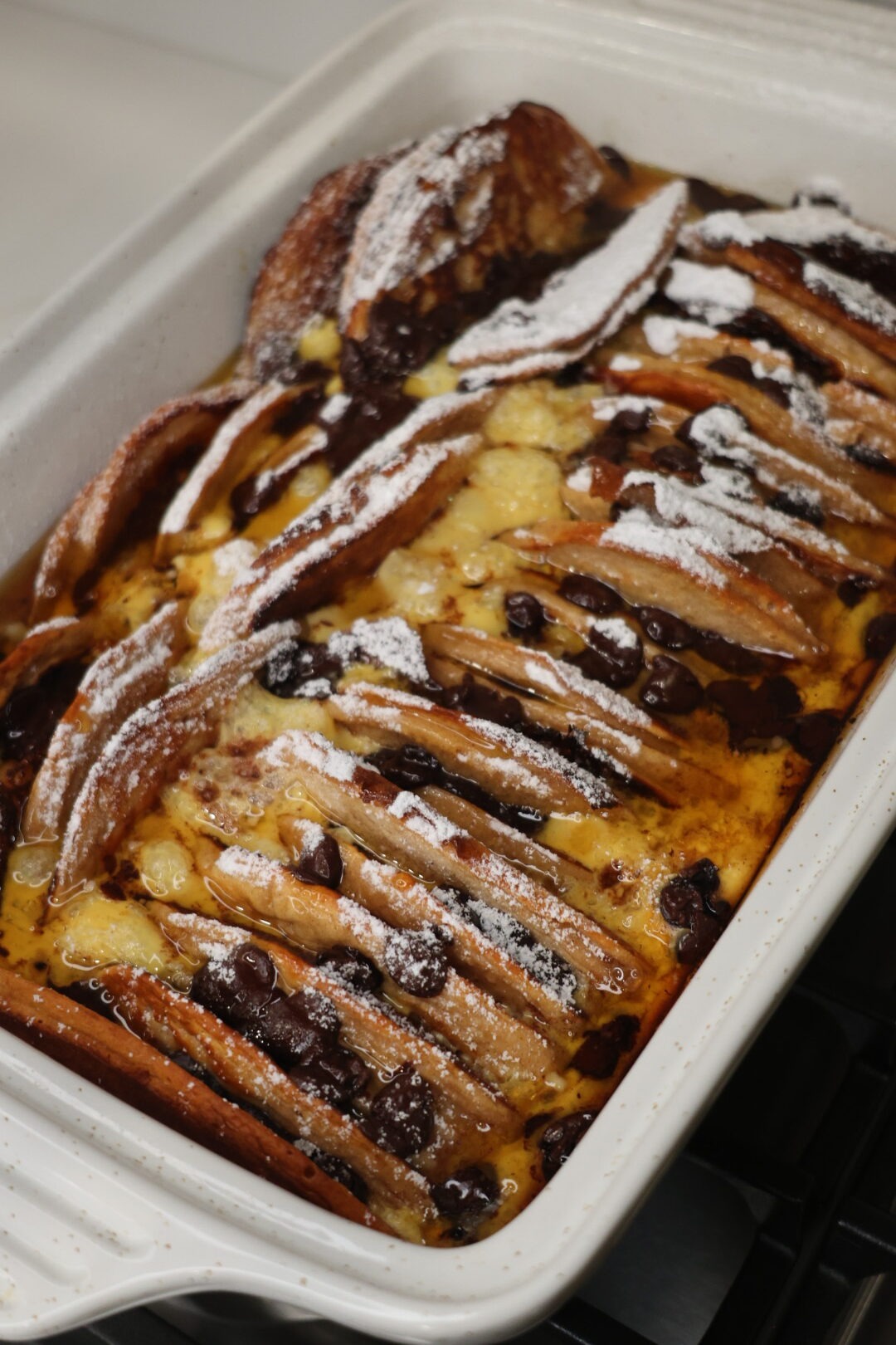 Sliced chocolate chip pancake casserole fresh from the oven