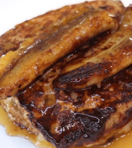 High Protein Peanut Butter Banana Stuffed French Toast made with Eat Royo Low Carb Artisan Bread, creamy peanut butter, mashed banana filling, and caramelized bananas on top.