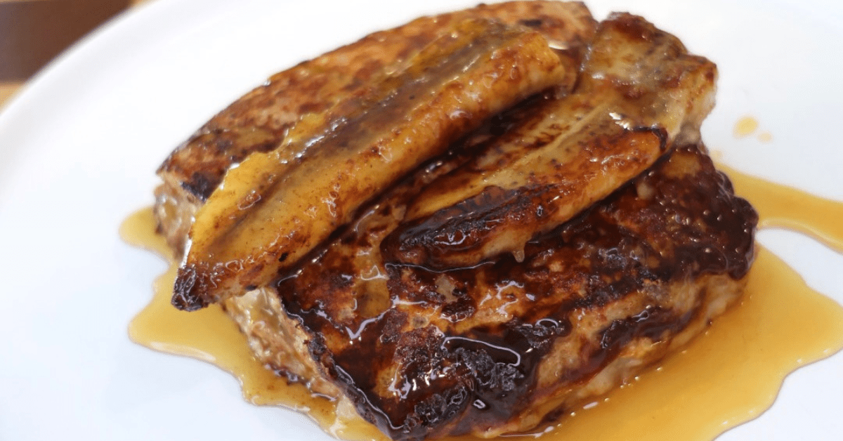 High Protein Peanut Butter Banana Stuffed French Toast made with Eat Royo Low Carb Artisan Bread, creamy peanut butter, mashed banana filling, and caramelized bananas on top.