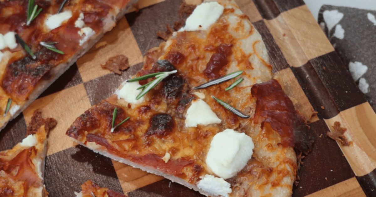 This Fig, Prosciutto & Goat Cheese Pizza is the perfect sweet and savory combination! Made with sourdough pizza crust, fig jam, prosciutto, mozzarella, and creamy goat cheese for an easy gourmet pizza at home.