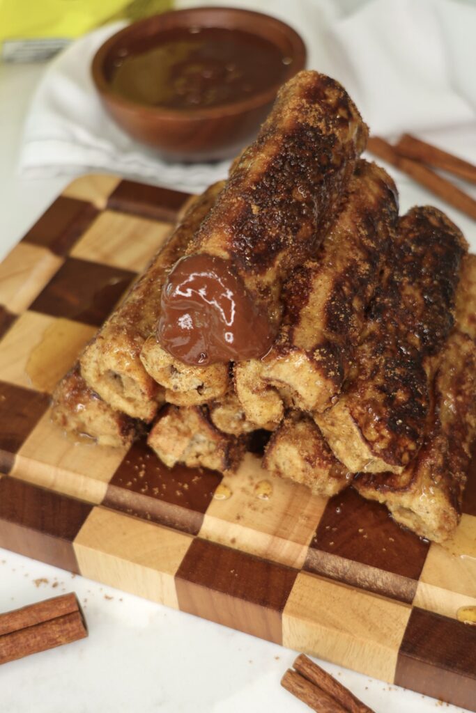 High Protein Chocolate Hazelnut French Toast Roll-Ups with a warm chocolate center and golden cinnamon coating.